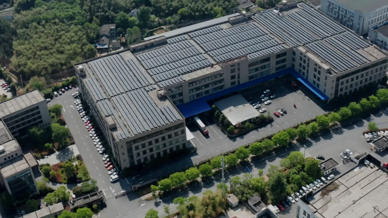 Aerial view of the Zhejiang Baizhijia factory campus with solar-panel roofs in Kangshan Industrial Park, Anji